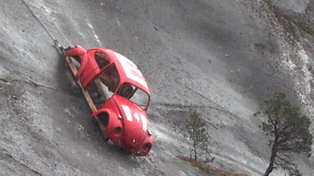 Why is there a Volkswagen Beetle hanging on the side of a mountain?